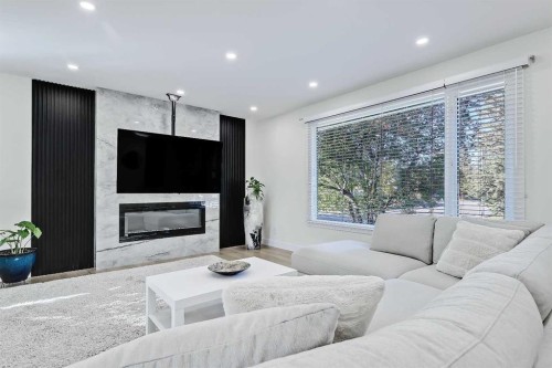 5219 Valiant Drive Nw, Calgary, AB - Indoor Photo Showing Living Room With Fireplace