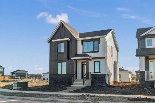 207 Perch Bend, Rural Rocky View County, AB - Outdoor With Facade