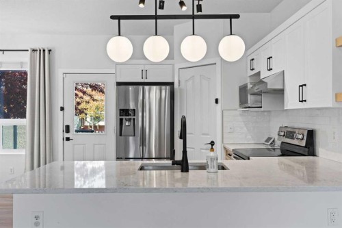 201-2066 Luxstone Boulevard Sw, Airdrie, AB - Indoor Photo Showing Kitchen With Upgraded Kitchen