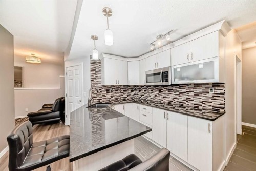 165 Hillcrest Drive Sw, Airdrie, AB - Indoor Photo Showing Kitchen With Upgraded Kitchen