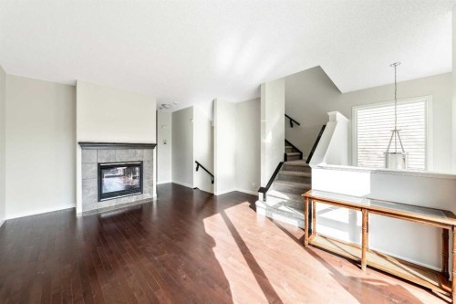 160 Sunset Point, Cochrane, AB - Indoor Photo Showing Living Room With Fireplace