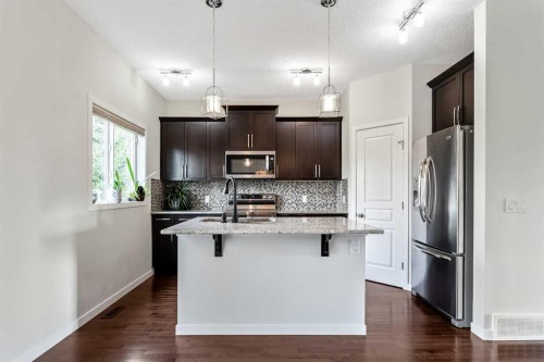160 Sunset Point, Cochrane, AB - Indoor Photo Showing Kitchen With Stainless Steel Kitchen With Upgraded Kitchen
