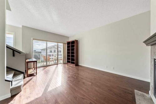 160 Sunset Point, Cochrane, AB - Indoor Photo Showing Other Room With Fireplace