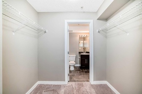 8201-403 Mackenzie Way Sw, Airdrie, AB - Indoor With Storage