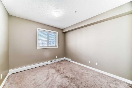 8201-403 Mackenzie Way Sw, Airdrie, AB - Indoor Photo Showing Other Room