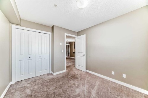 8201-403 Mackenzie Way Sw, Airdrie, AB - Indoor Photo Showing Other Room