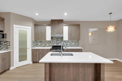 87 Baysprings Way Sw, Airdrie, AB - Indoor Photo Showing Kitchen With Double Sink With Upgraded Kitchen