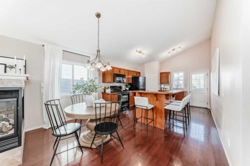 1046 Channelside Way Sw, Airdrie, AB - Indoor Photo Showing Dining Room With Fireplace