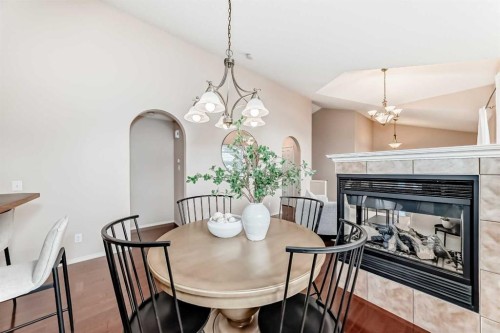1046 Channelside Way Sw, Airdrie, AB - Indoor Photo Showing Dining Room With Fireplace