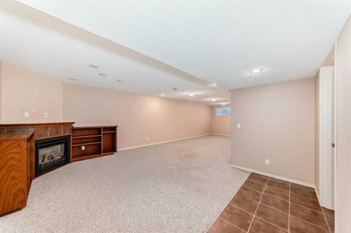 1046 Channelside Way Sw, Airdrie, AB - Indoor Photo Showing Other Room With Fireplace