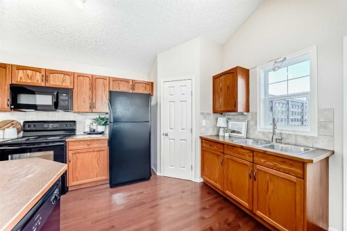 1046 Channelside Way Sw, Airdrie, AB - Indoor Photo Showing Kitchen With Double Sink