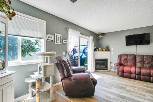 702-760 Railway Gate Sw, Airdrie, AB - Indoor Photo Showing Living Room With Fireplace