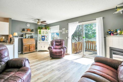 702-760 Railway Gate Sw, Airdrie, AB - Indoor Photo Showing Living Room With Fireplace