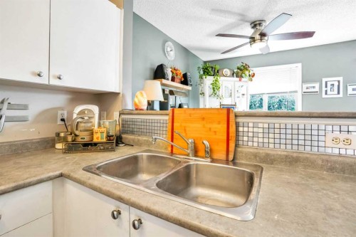 702-760 Railway Gate Sw, Airdrie, AB - Indoor Photo Showing Kitchen With Double Sink
