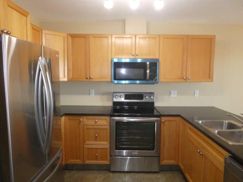 310 Sunrise Terrace Ne, High River, AB - Indoor Photo Showing Kitchen With Double Sink