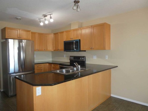 310 Sunrise Terrace Ne, High River, AB - Indoor Photo Showing Kitchen With Double Sink