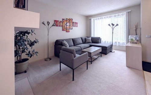 12 Shawbrooke Court Sw, Calgary, AB - Indoor Photo Showing Living Room