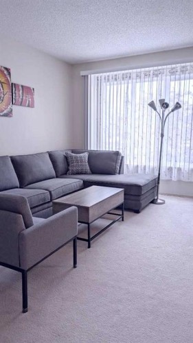 12 Shawbrooke Court Sw, Calgary, AB - Indoor Photo Showing Living Room