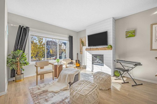 8048 Masters Boulevard Se, Calgary, AB - Indoor Photo Showing Living Room With Fireplace
