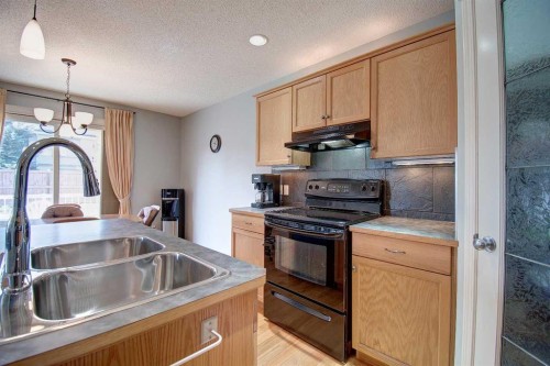 209 Sagewood Place Sw, Airdrie, AB - Indoor Photo Showing Kitchen With Double Sink