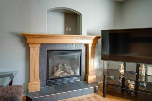 209 Sagewood Place Sw, Airdrie, AB - Indoor Photo Showing Living Room With Fireplace