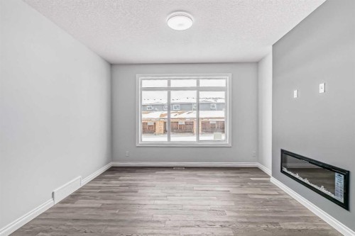 37 Southborough Lane, Cochrane, AB - Indoor Photo Showing Other Room With Fireplace