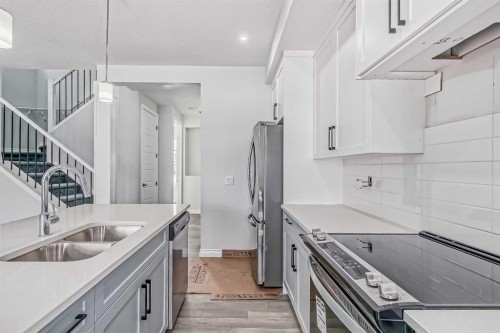37 Southborough Lane, Cochrane, AB - Indoor Photo Showing Kitchen With Double Sink With Upgraded Kitchen