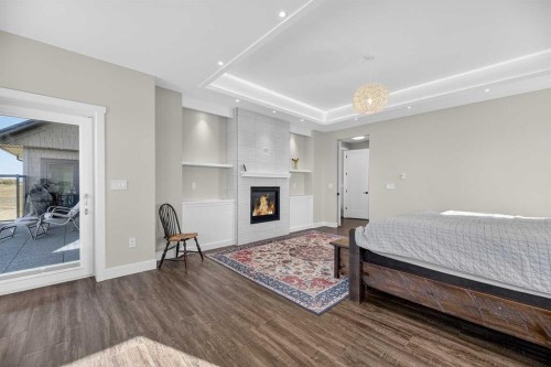 1474 Twp314, Rural Mountain View County, AB - Indoor Photo Showing Bedroom With Fireplace