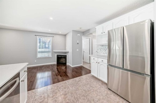 95 Hidden Creek Rise Nw, Calgary, AB - Indoor Photo Showing Kitchen With Fireplace