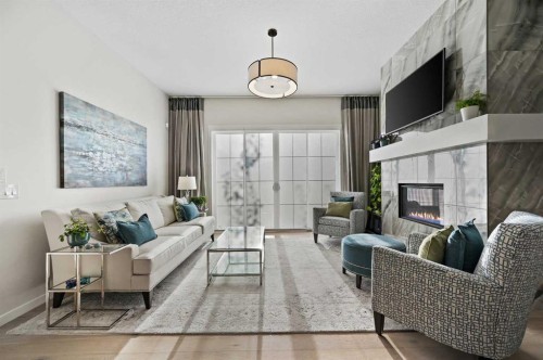 12 Cranbrook Mews Se, Calgary, AB - Indoor Photo Showing Living Room With Fireplace