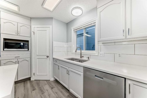 10134 Hidden Valley Drive Nw, Calgary, AB - Indoor Photo Showing Kitchen With Double Sink