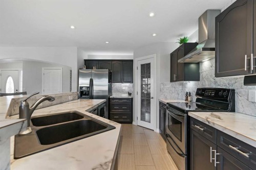 60 Canoe Cove Sw, Airdrie, AB - Indoor Photo Showing Kitchen With Double Sink With Upgraded Kitchen