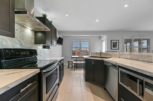 60 Canoe Cove Sw, Airdrie, AB - Indoor Photo Showing Kitchen With Double Sink