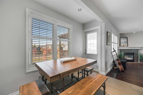 60 Canoe Cove Sw, Airdrie, AB - Indoor Photo Showing Dining Room With Fireplace