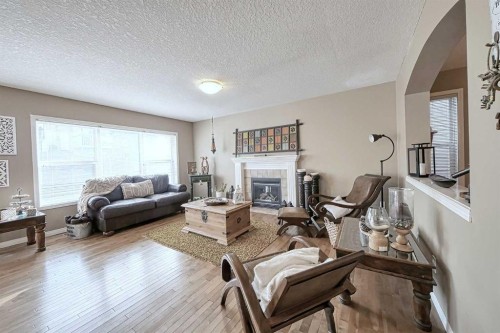 73 Everwoods Road Sw, Calgary, AB - Indoor Photo Showing Living Room With Fireplace