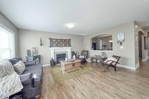 73 Everwoods Road Sw, Calgary, AB - Indoor Photo Showing Living Room With Fireplace