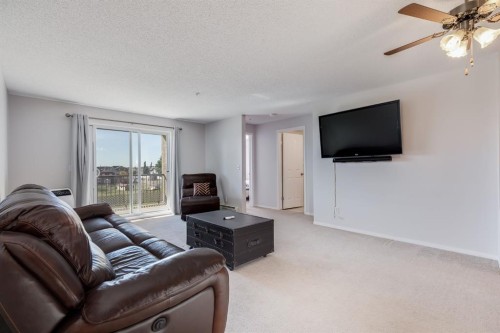 7308-304 Mackenzie Way Sw, Airdrie, AB - Indoor Photo Showing Living Room