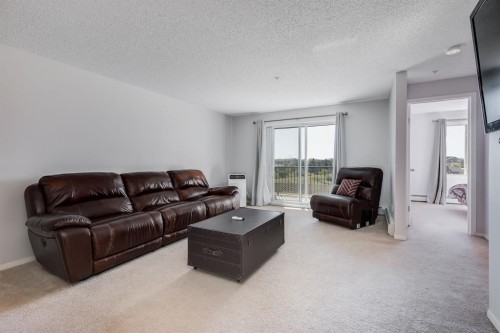 7308-304 Mackenzie Way Sw, Airdrie, AB - Indoor Photo Showing Living Room
