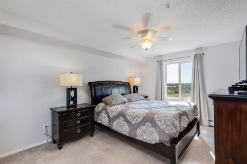 7308-304 Mackenzie Way Sw, Airdrie, AB - Indoor Photo Showing Bedroom