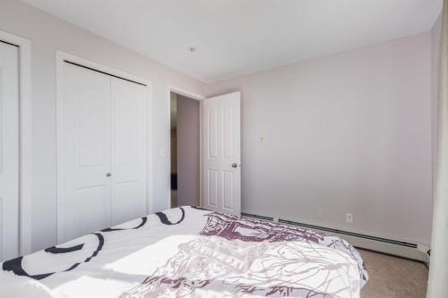 7308-304 Mackenzie Way Sw, Airdrie, AB - Indoor Photo Showing Bedroom