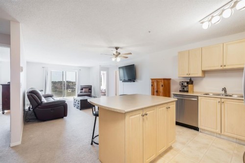 7308-304 Mackenzie Way Sw, Airdrie, AB - Indoor Photo Showing Kitchen With Double Sink