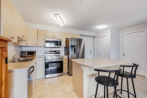 7308-304 Mackenzie Way Sw, Airdrie, AB - Indoor Photo Showing Kitchen With Double Sink