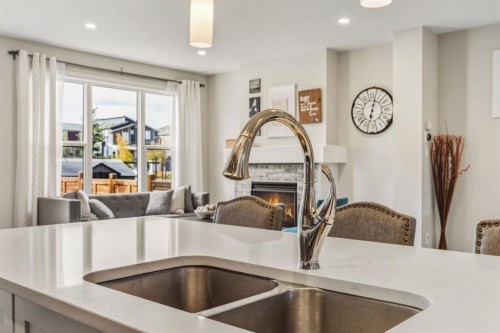 59 Sage Bluff Road Nw, Calgary, AB - Indoor Photo Showing Kitchen With Fireplace With Double Sink
