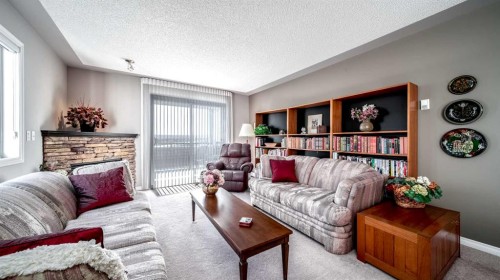 2206-7451 Springbank Boulevard Sw, Calgary, AB - Indoor Photo Showing Living Room