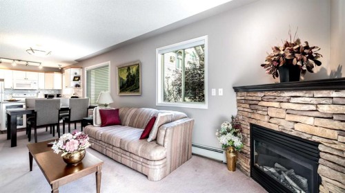 2206-7451 Springbank Boulevard Sw, Calgary, AB - Indoor Photo Showing Living Room With Fireplace