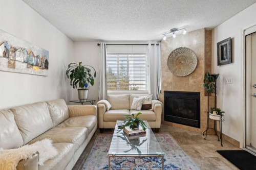 204-30 Sierra Morena Mews Sw, Calgary, AB - Indoor Photo Showing Living Room With Fireplace