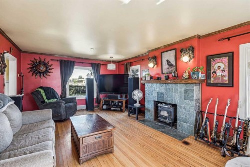 663 10 Avenue South, Carstairs, AB - Indoor Photo Showing Living Room With Fireplace