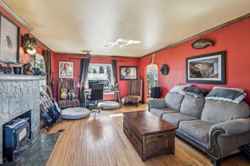 663 10 Avenue South, Carstairs, AB - Indoor Photo Showing Living Room With Fireplace