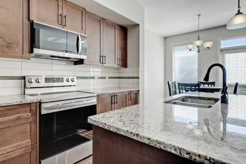 401-1086 Williamstown Boulevard Nw, Airdrie, AB - Indoor Photo Showing Kitchen With Double Sink With Upgraded Kitchen