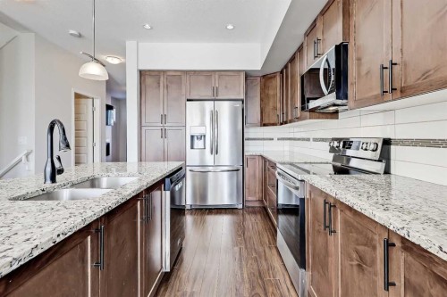 401-1086 Williamstown Boulevard Nw, Airdrie, AB - Indoor Photo Showing Kitchen With Stainless Steel Kitchen With Double Sink With Upgraded Kitchen